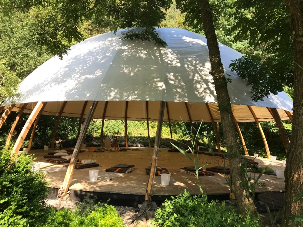 The meditation dome nestled in the forest at a retreat in Sweden